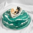 Sea-shaped cake, newlyweds in a boat