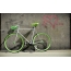 Lime bicycle on the background of the old wall