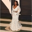 Serena in a white lace dress with a deep neckline