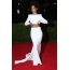 Rihanna in a white top and long skirt