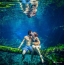Boy and girl kiss in the water