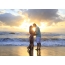 Loving couple on the beach, beautiful sunset